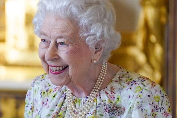 Britain's Queen Elizabeth II smiles as she arrives to view a display of artefacts from Halcyon Days to commemorate the company's 70th anniversary in the White Drawing Room at Windsor Castle on March 23, 2022. - The Queen viewed a selection of hand-decorated archive enamelware and fine bone china from Halcyon Days, including their earliest designs from the 1950s. (Photo by Steve Parsons / POOL / AFP) (Photo by STEVE PARSONS/POOL/AFP via Getty Images)